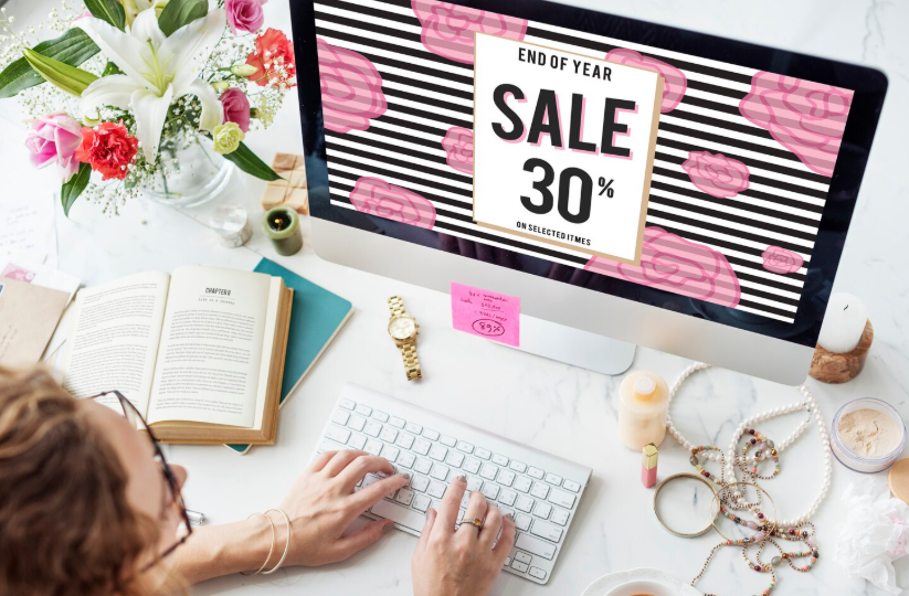 Browsing an end-of-year sale on a computer while planning purchases during key flash sale hours.