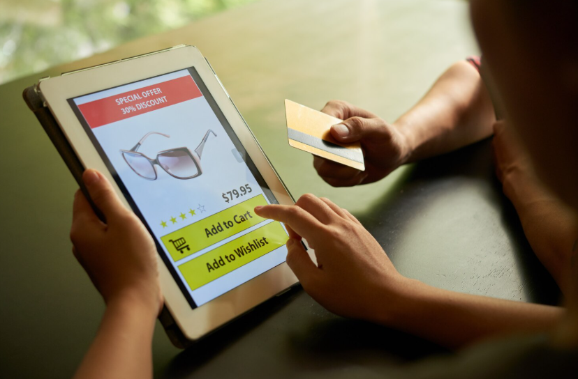 Online shopper comparing outlet-style prices on a tablet product page before completing the purchase.