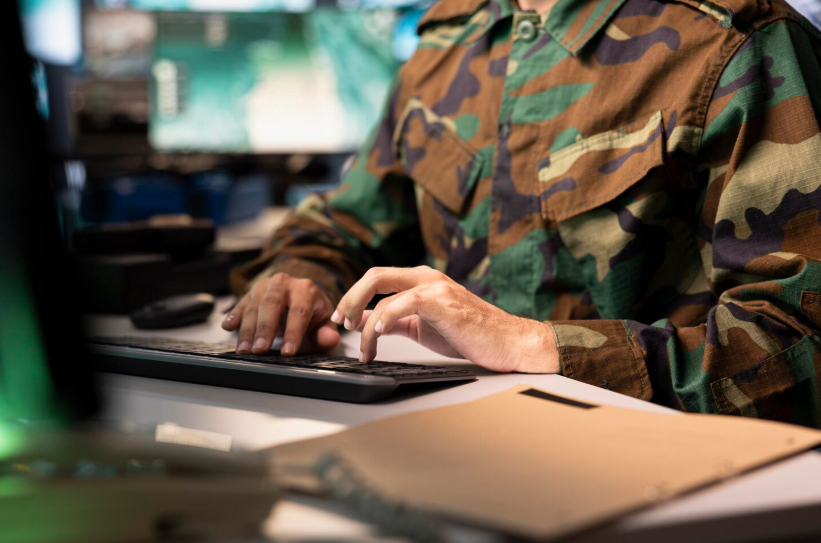 Military service member verifying eligibility online for hidden student teacher military discounts.