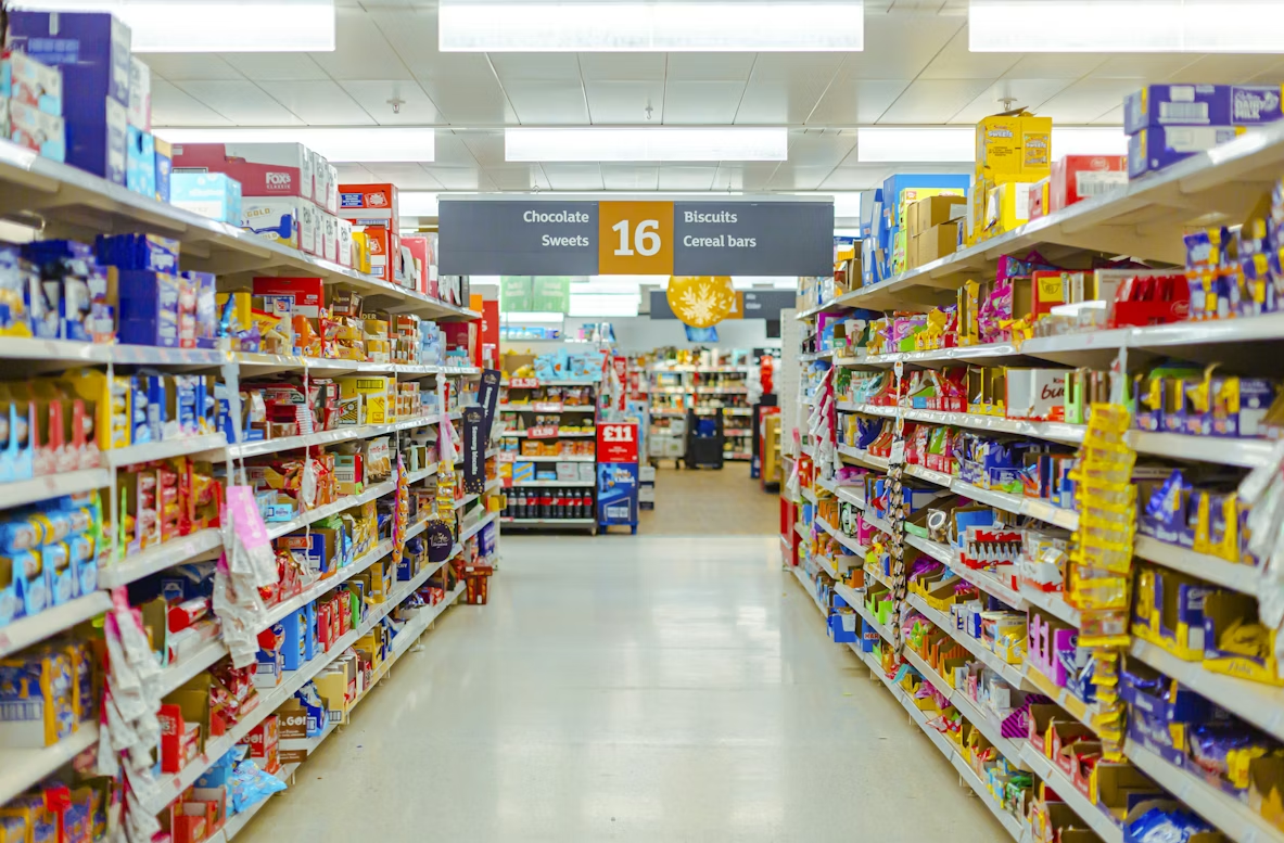 High-margin grocery store snack aisle designed to trigger impulse buys, illustrating grocery store layout hacks.